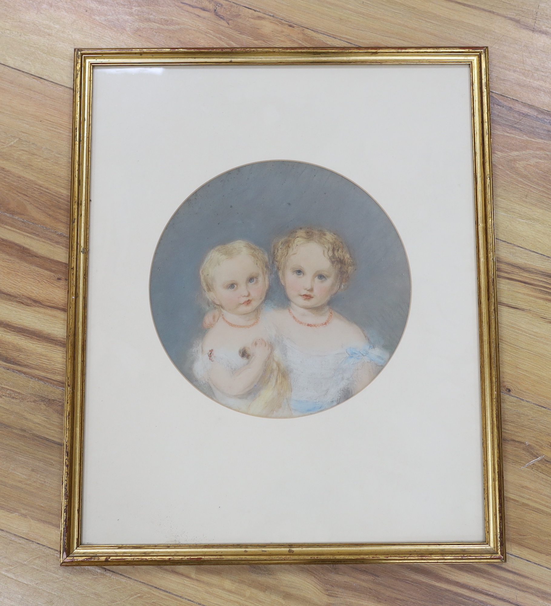 Victorian School, pastel, Two young children wearing coral necklaces, tondo, 28cm